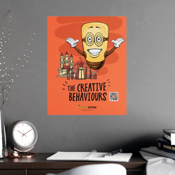 A Spark Poster: Light Up the Room (and your Creativity) hangs on a gray wall, showing a smiling cartoon lightbulb with arms, city sketches, and “The Creative Behaviours” above a QR code. Below is a neat desk with papers, a plant, and a clock.