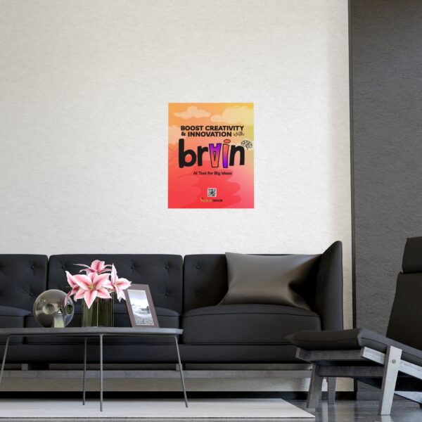 A modern living room with a black sofa, gray chair, glass table with pink lilies, and a colorful brAIn Poster: Visualize Your Innovation Mindset displayed on the wall.